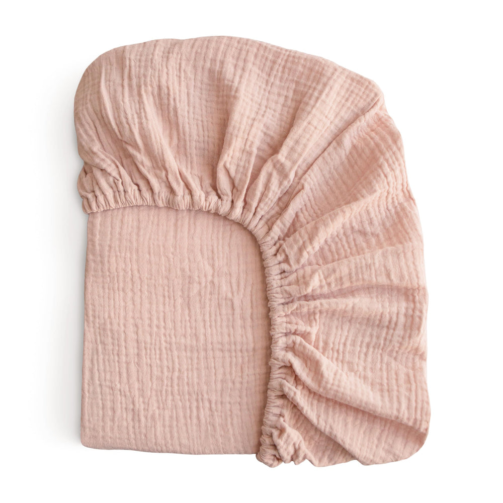mushie extra soft muslin fitted crib sheet blush close-up showing buttery softness for baby skin