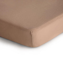 Mushie fitted crib sheet with elastic fit stays snug on standard crib mattresses.