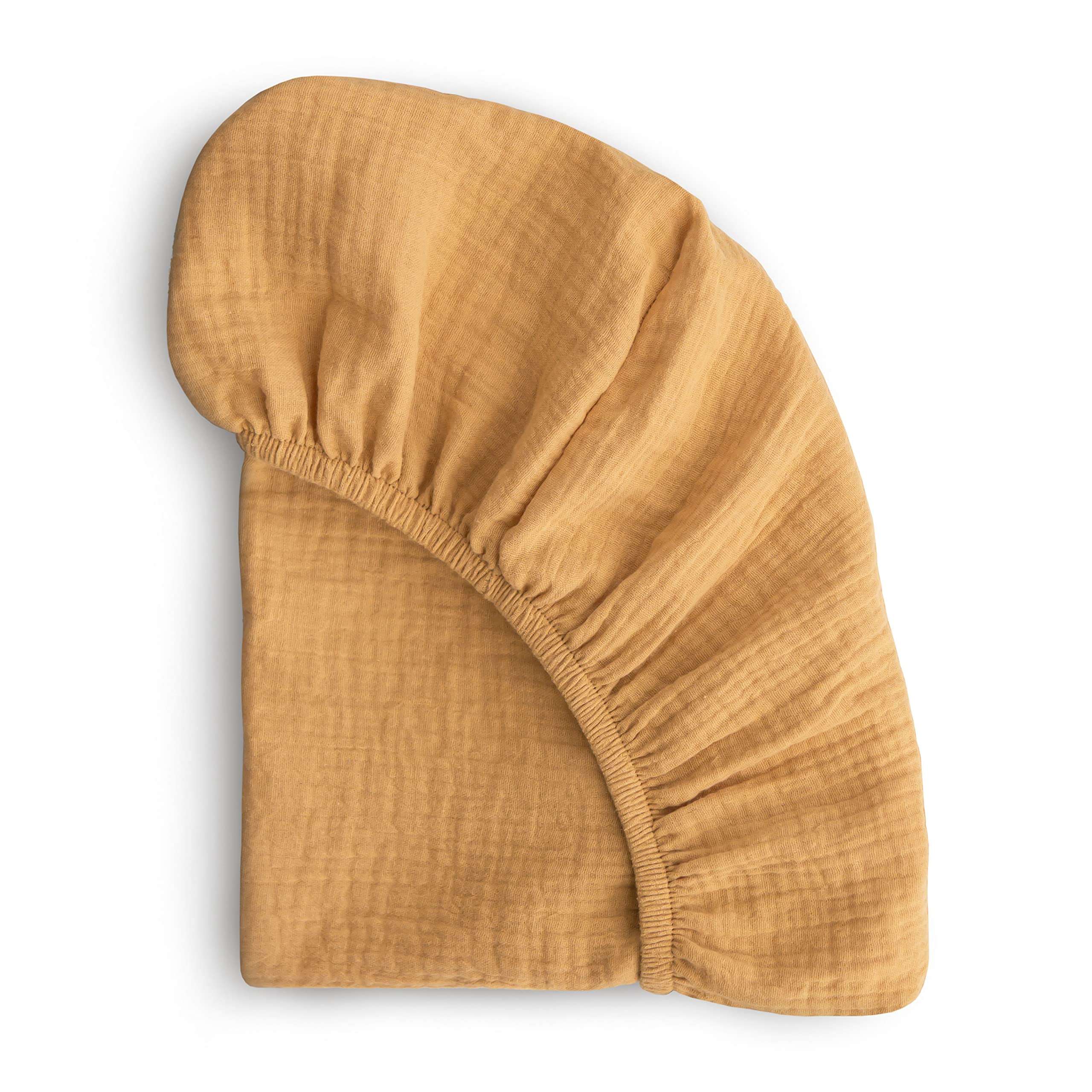 Mushie extra-soft muslin fitted crib sheet in Fall Yellow on a crib mattress for cozy, breathable sleep.