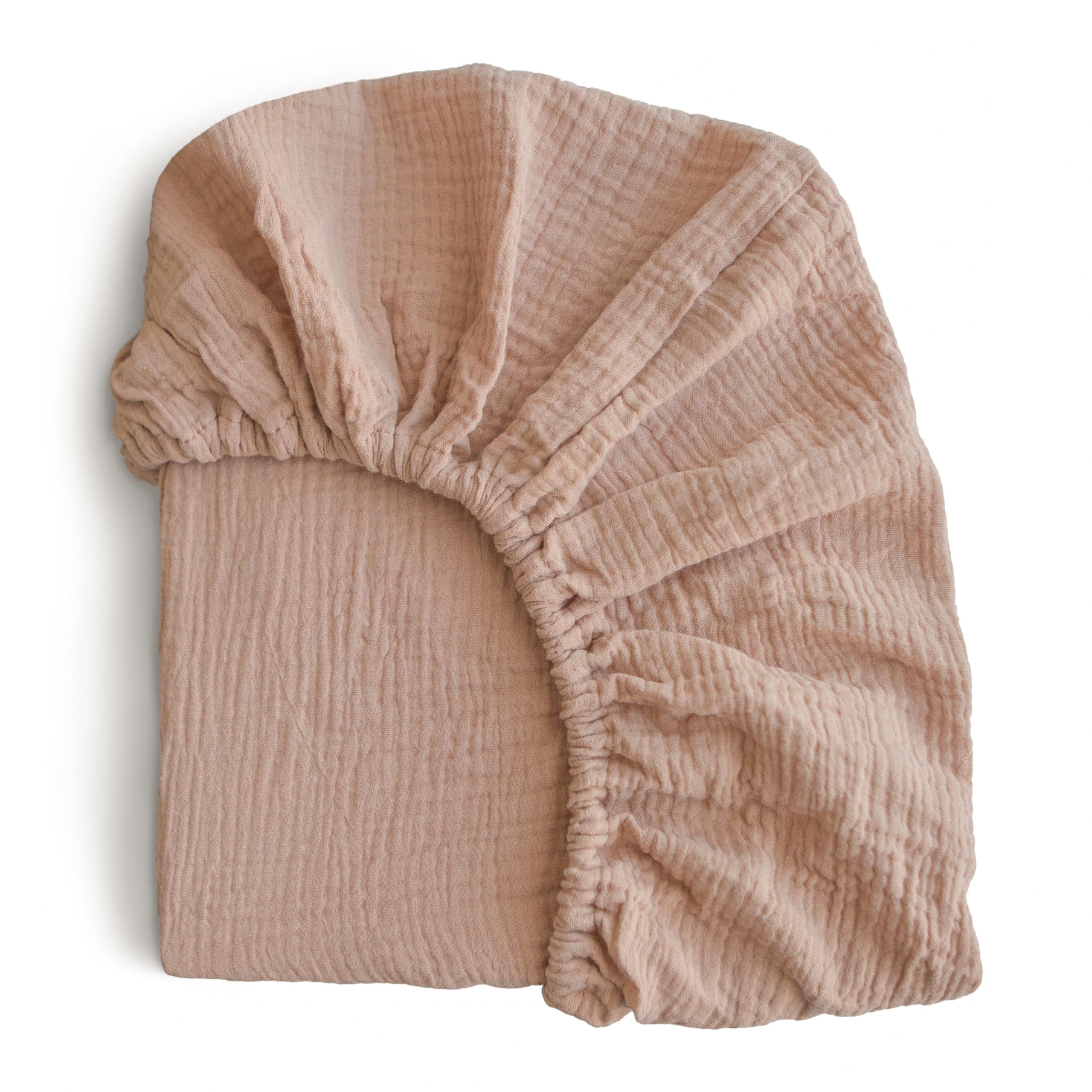 Mushie extra soft muslin fitted crib sheet texture shows breathable cotton for gentle baby comfort.