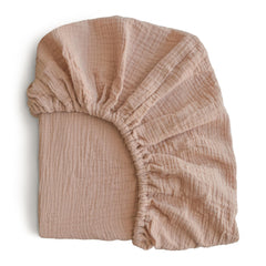 Mushie extra soft muslin fitted crib sheet texture shows breathable cotton for gentle baby comfort.