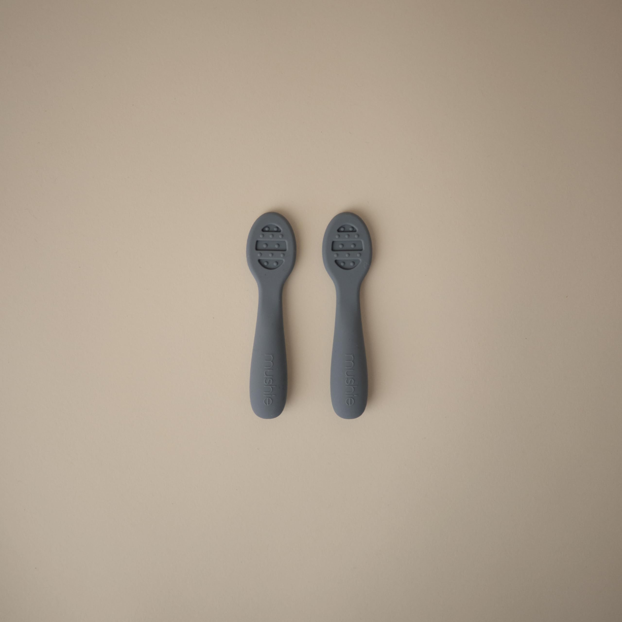 Mushie spoons with sensory dots aiding teething comfort