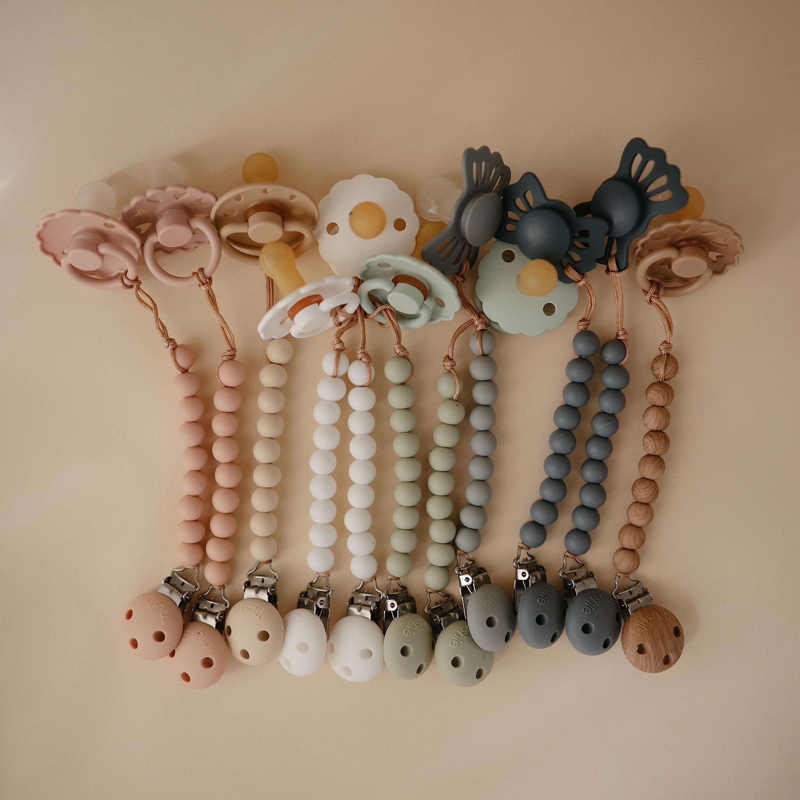 Mushie Hera pacifier clip clean and dry after hand washing display.