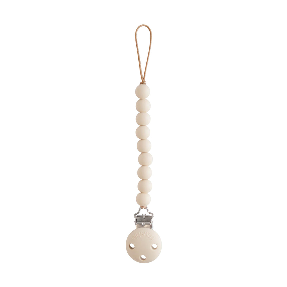 Mushie Hera pacifier clip shifting sand closeup shows safe silicone beads for soothing on the go.
