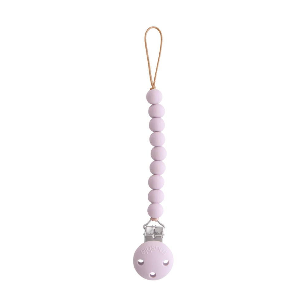 Mushie Hera pacifier clip soft lilac close-up showing secure on-the-go attachment