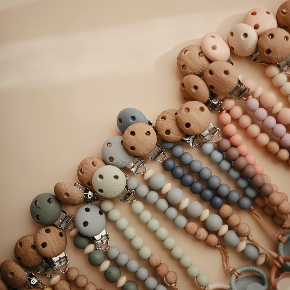 Mushie Hera Sage pacifier clip color palette showcasing calming tones.