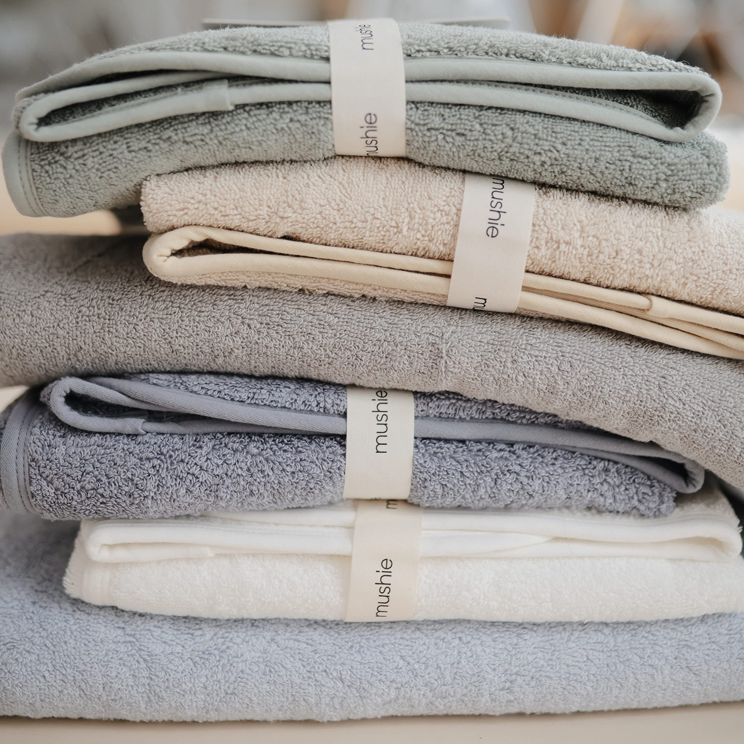 Mushie hooded towel blue flat lay highlighting color and size