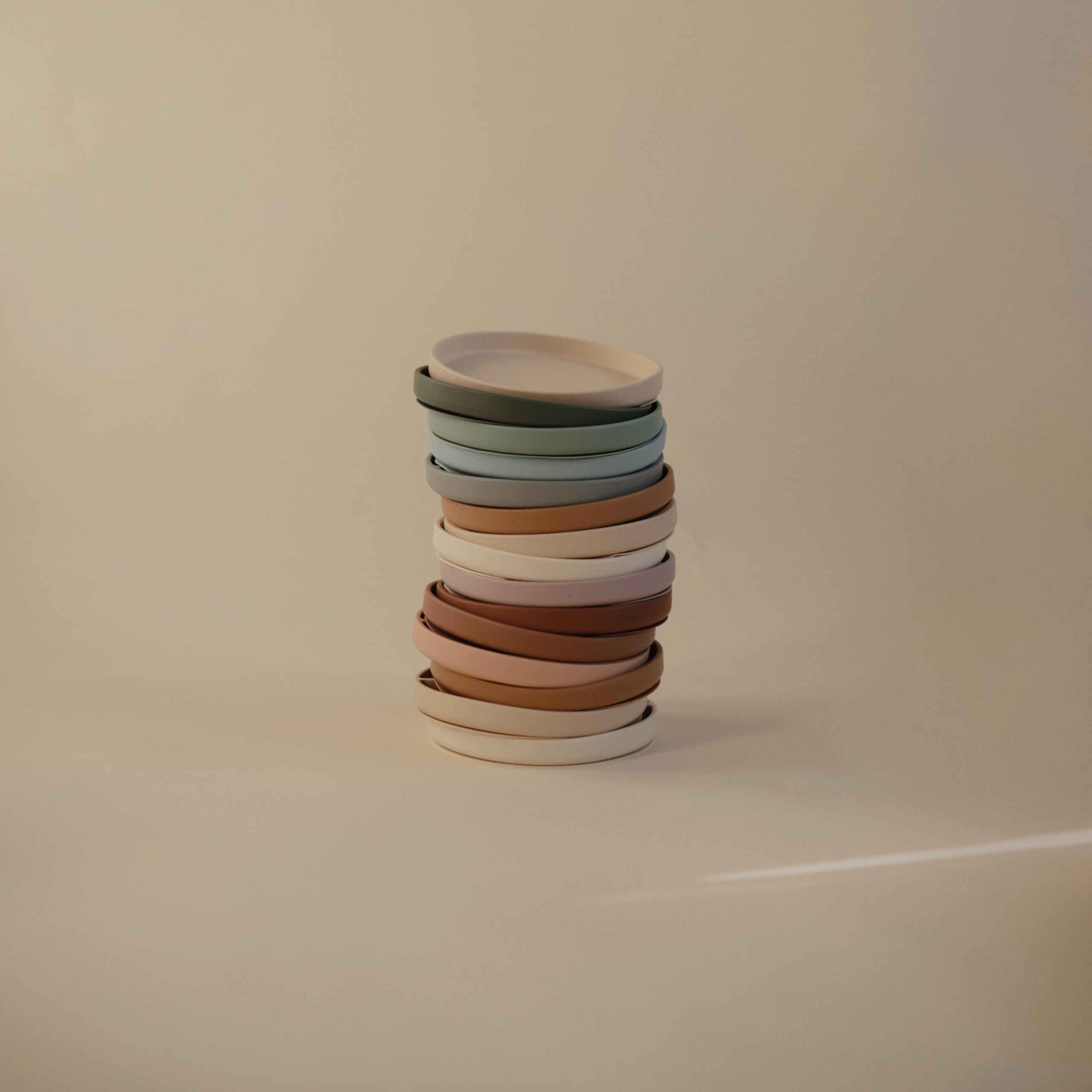 Mushie kid-friendly mealtime plate on table with non-slip base.