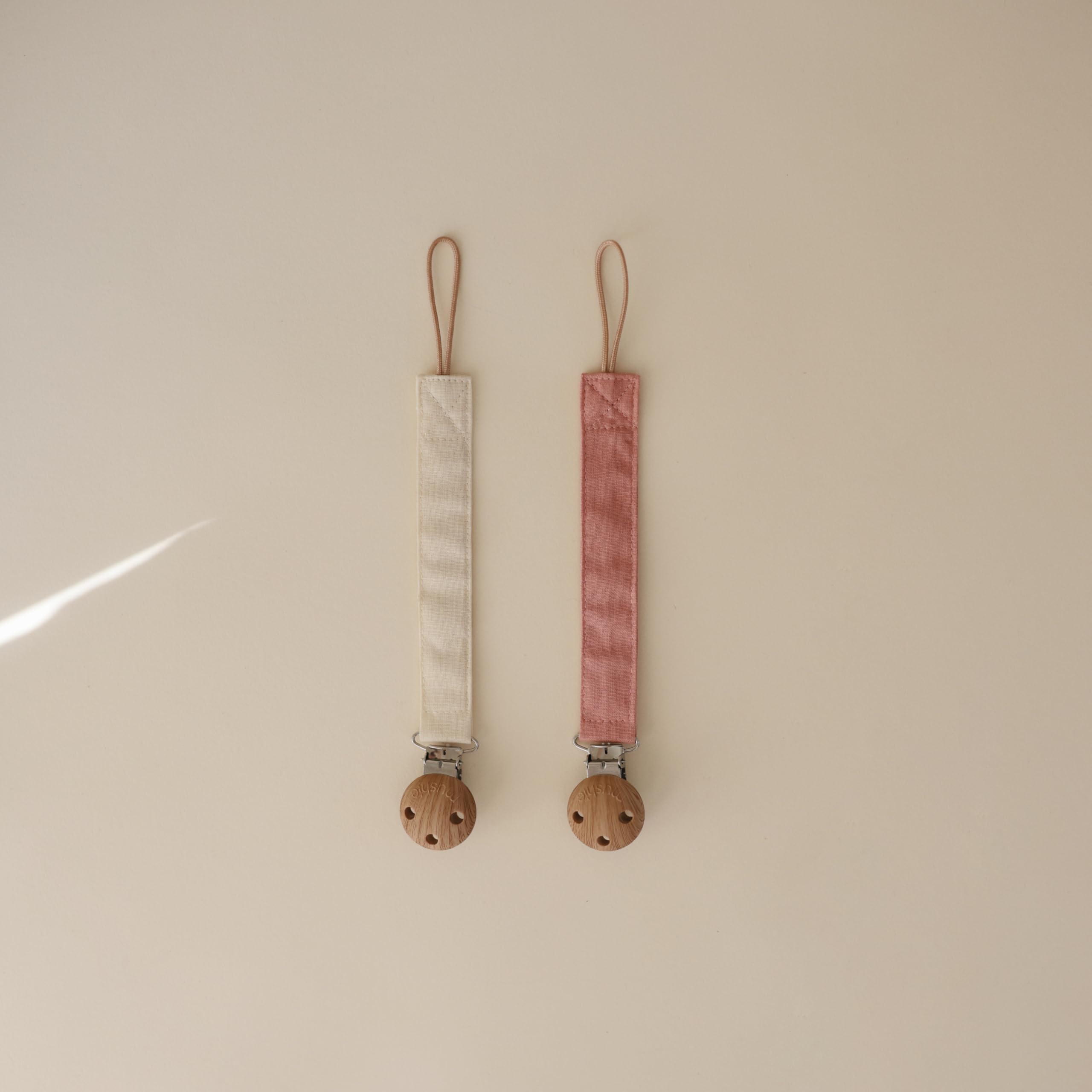 Mushie linen pacifier clip loop compatibility indicating fits most pacifiers.