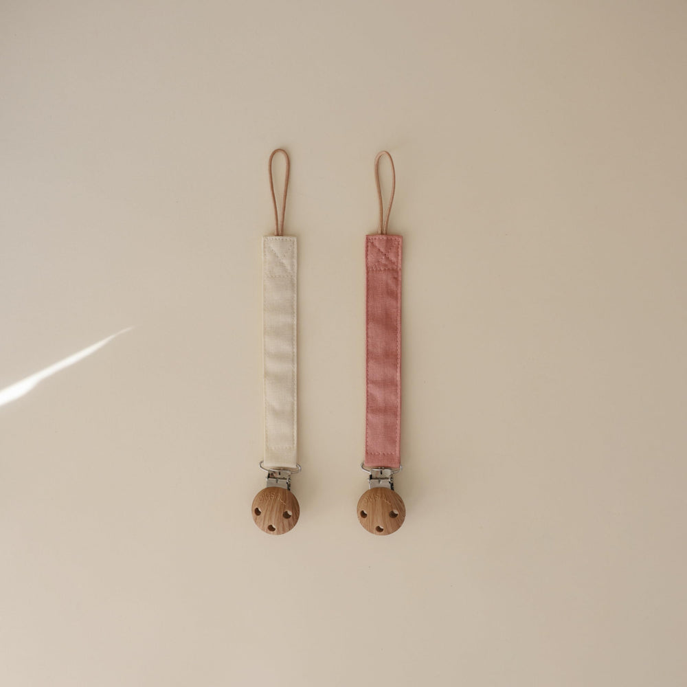 Mushie linen pacifier clip loop compatibility indicating fits most pacifiers.
