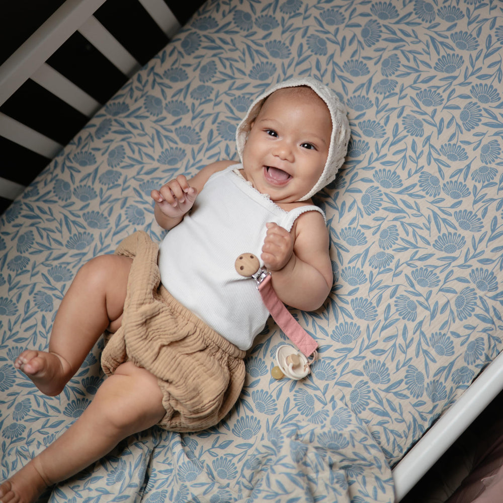 Mushie linen pacifier clip Shifting Sand closeup showing soft fabric and durable loop design.