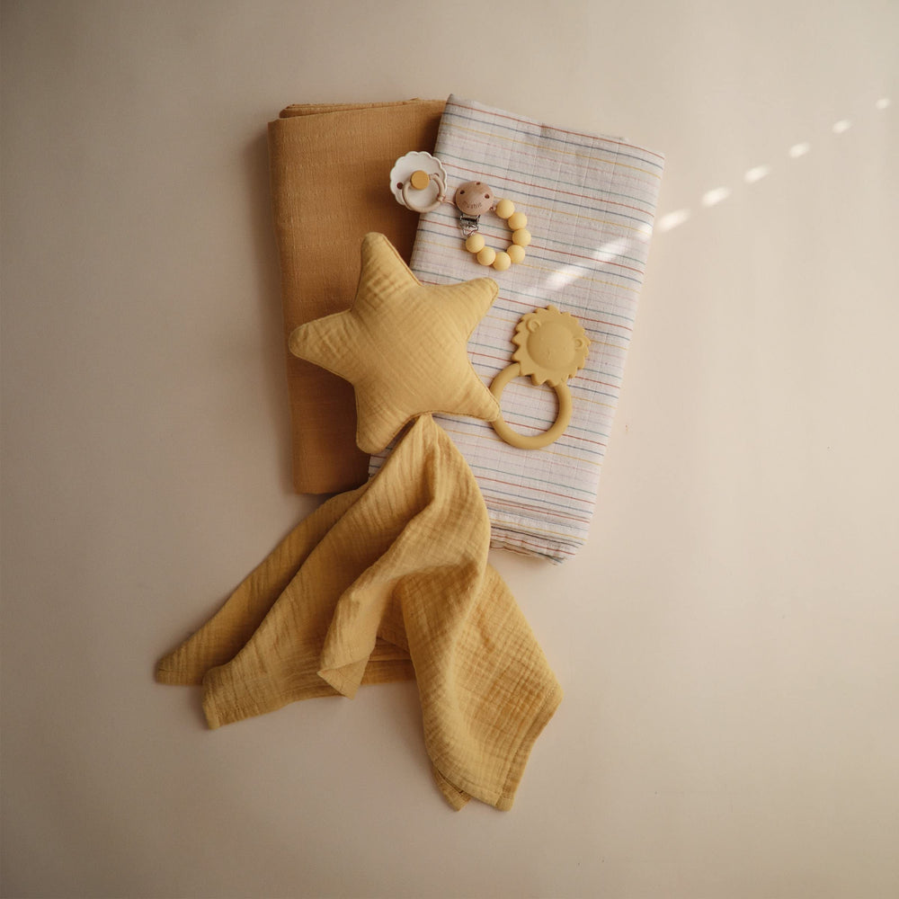 Mushie Lion teether colorways; vibrant option to match baby gear