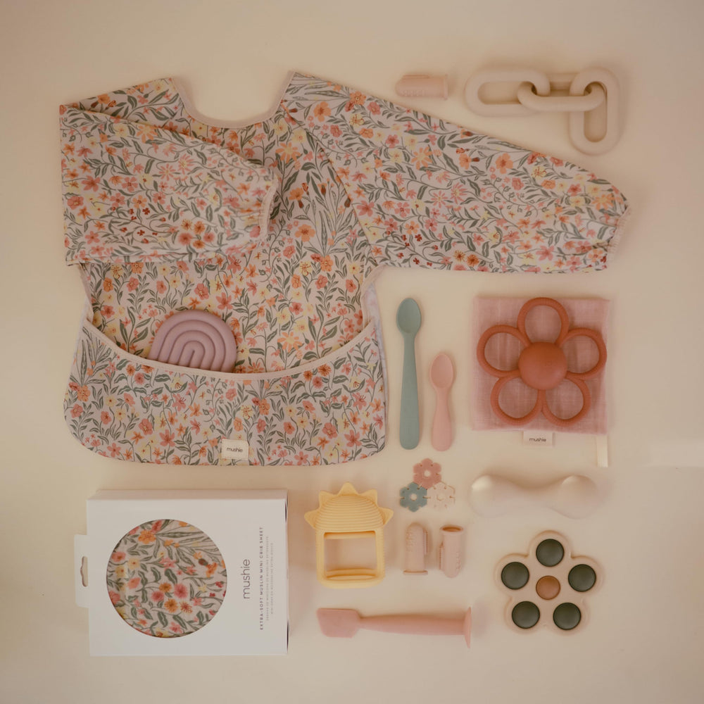 Mushie Long Sleeve Bib Pastel Blooms machine washable for quick cleanup after meals.