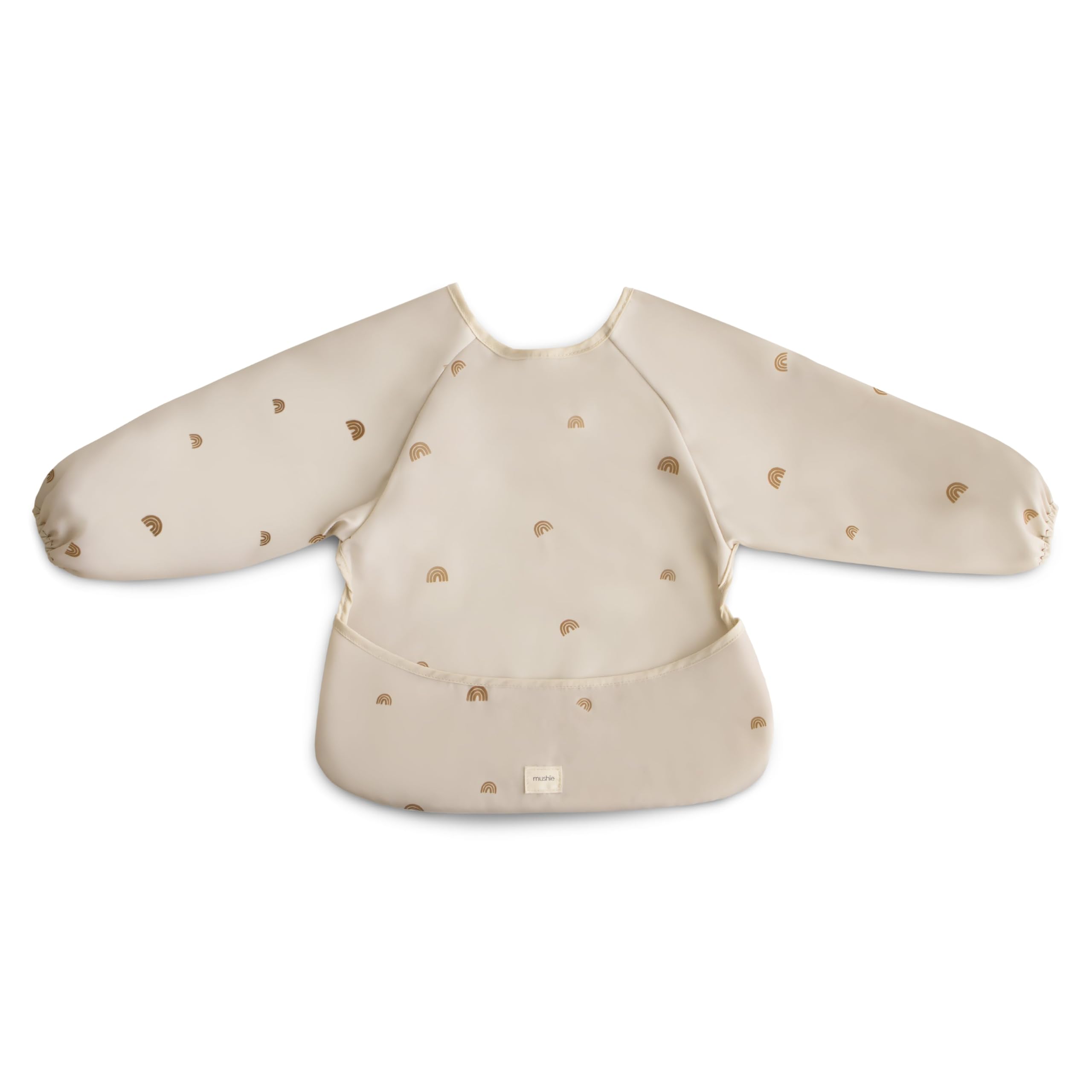 Mushie long sleeve bib Rainbows worn by baby showing full coverage during meals.