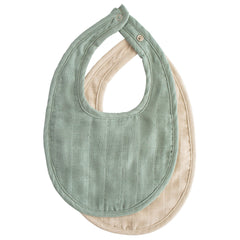 Mushie muslin bib with adjustable closure in Roman Green and Fog protects outfits from drool.