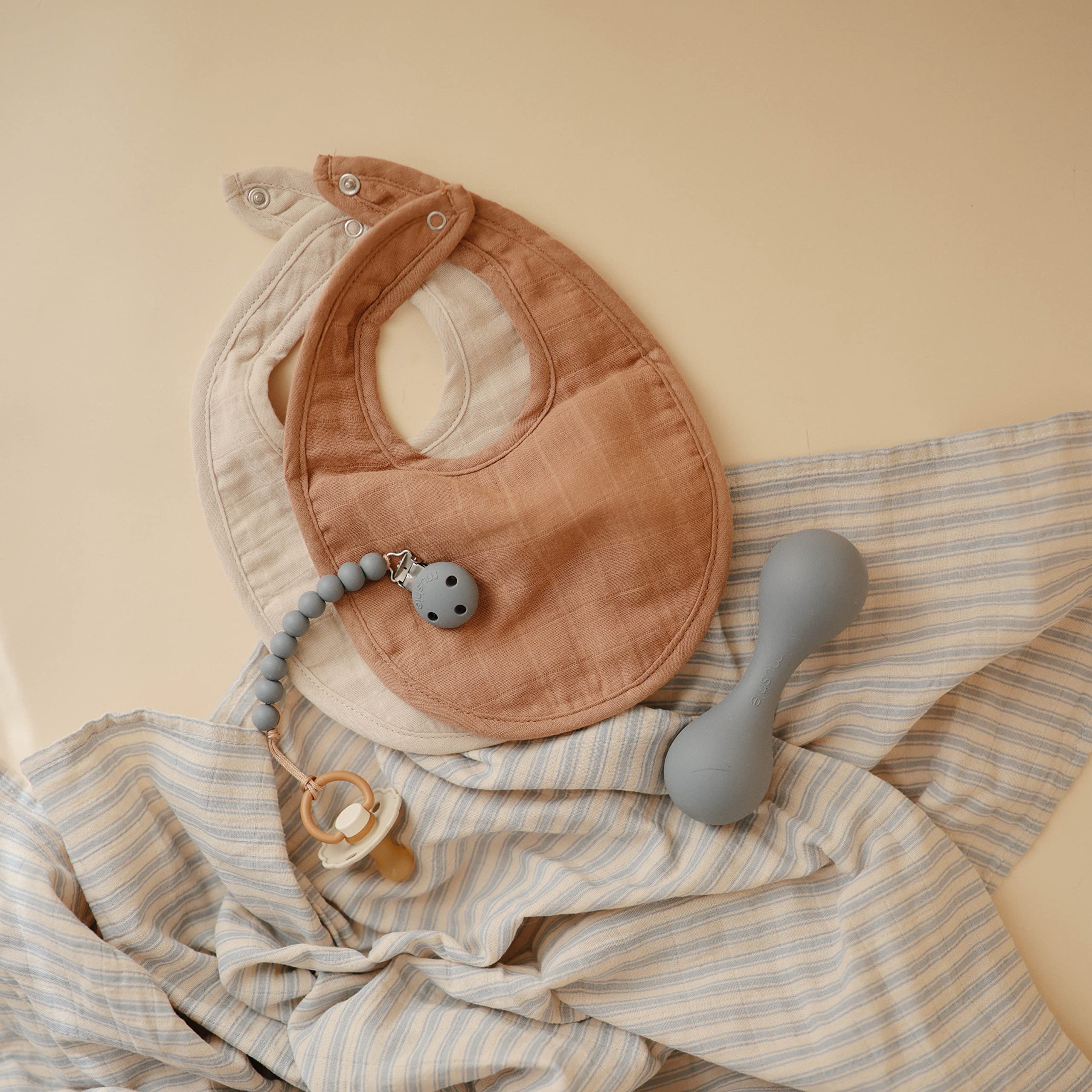 mushie muslin bib care instructions show air-dry method