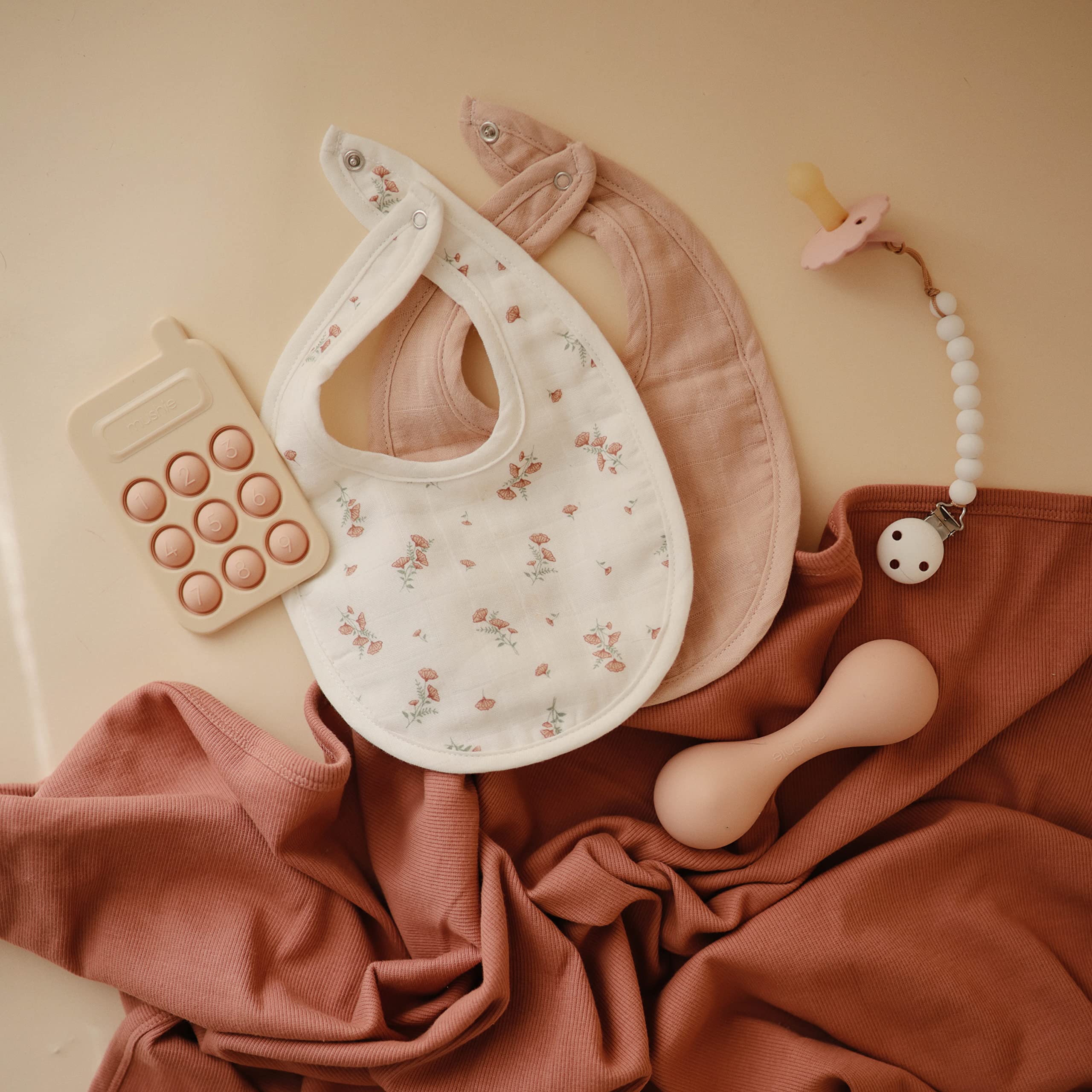 Mushie muslin bib closeup-organic-cotton highlights 100% organic cotton softness.