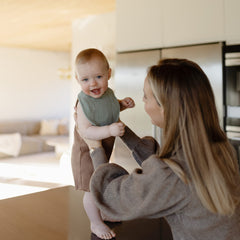 Mushie muslin bib made of organic cotton offers soft, breathable wear for babies.
