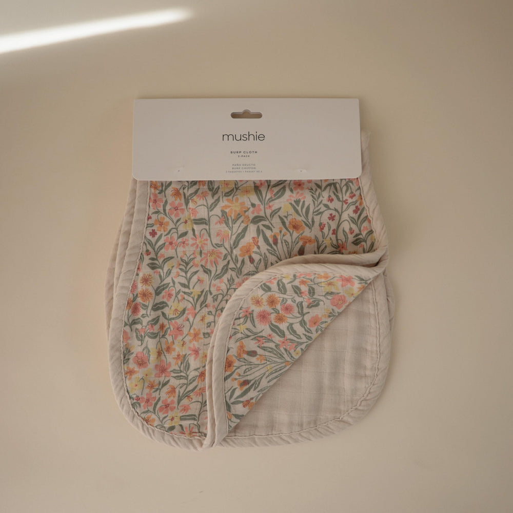 Mushie muslin burp cloths closeup highlights pre-washed softness against baby skin.