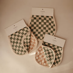 Mushie muslin burp cloth in natural check laid flat, lightweight and breathable for everyday care.