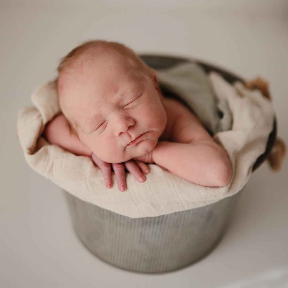 Mushie Muslin Cloth Fog changing-table-use demonstrates gentle layer for diaper changes