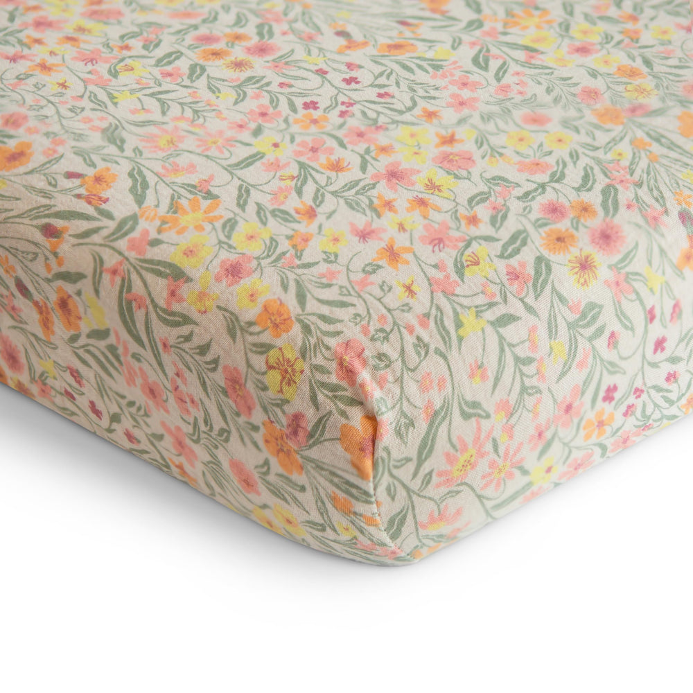 Mushie pastel blooms muslin crib sheet uses breathable fabric for cozy sleep environments.