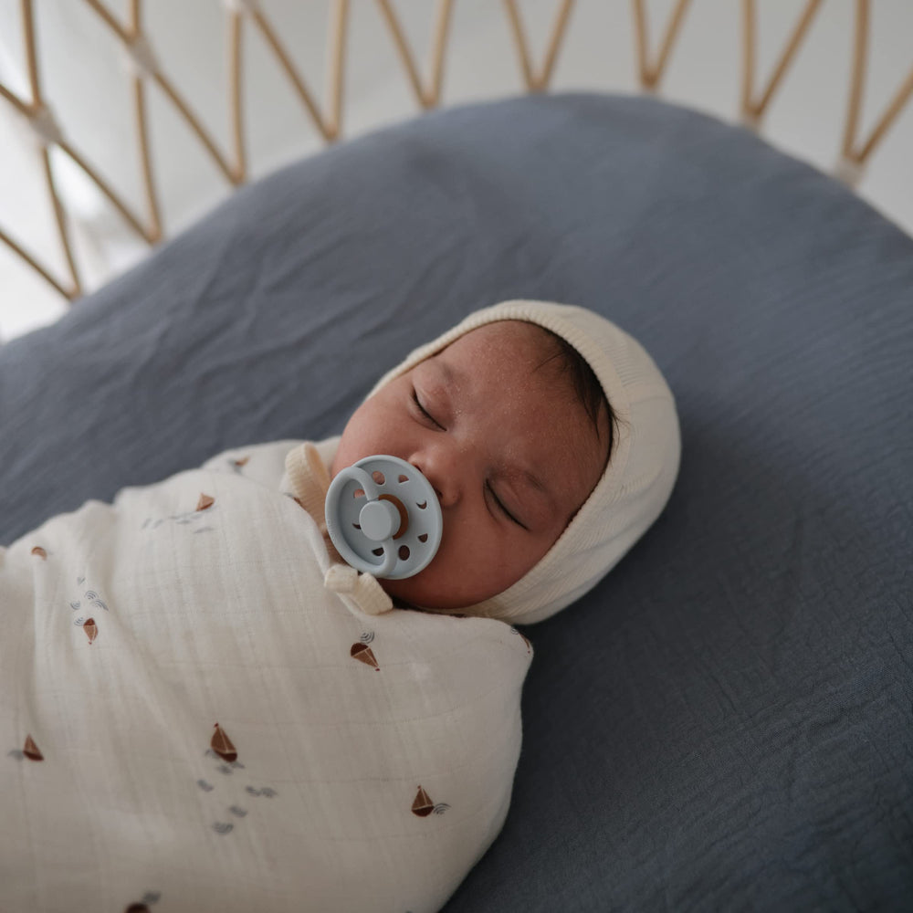 Mushie breathable muslin texture demonstrates airy comfort during naps.