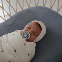 Mushie breathable muslin texture demonstrates airy comfort during naps.