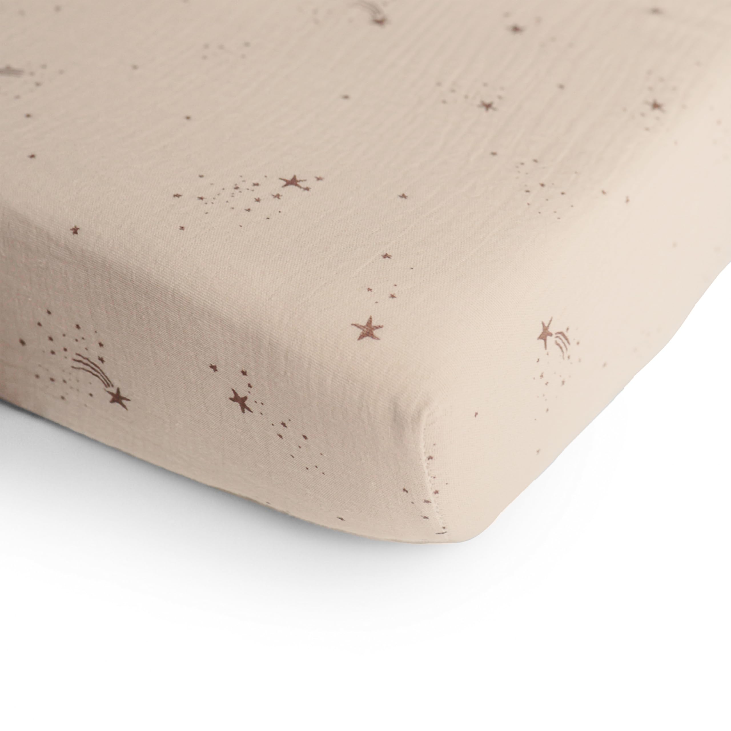 Mushie muslin fitted crib sheet soft texture on baby bed for cozy sleep surface