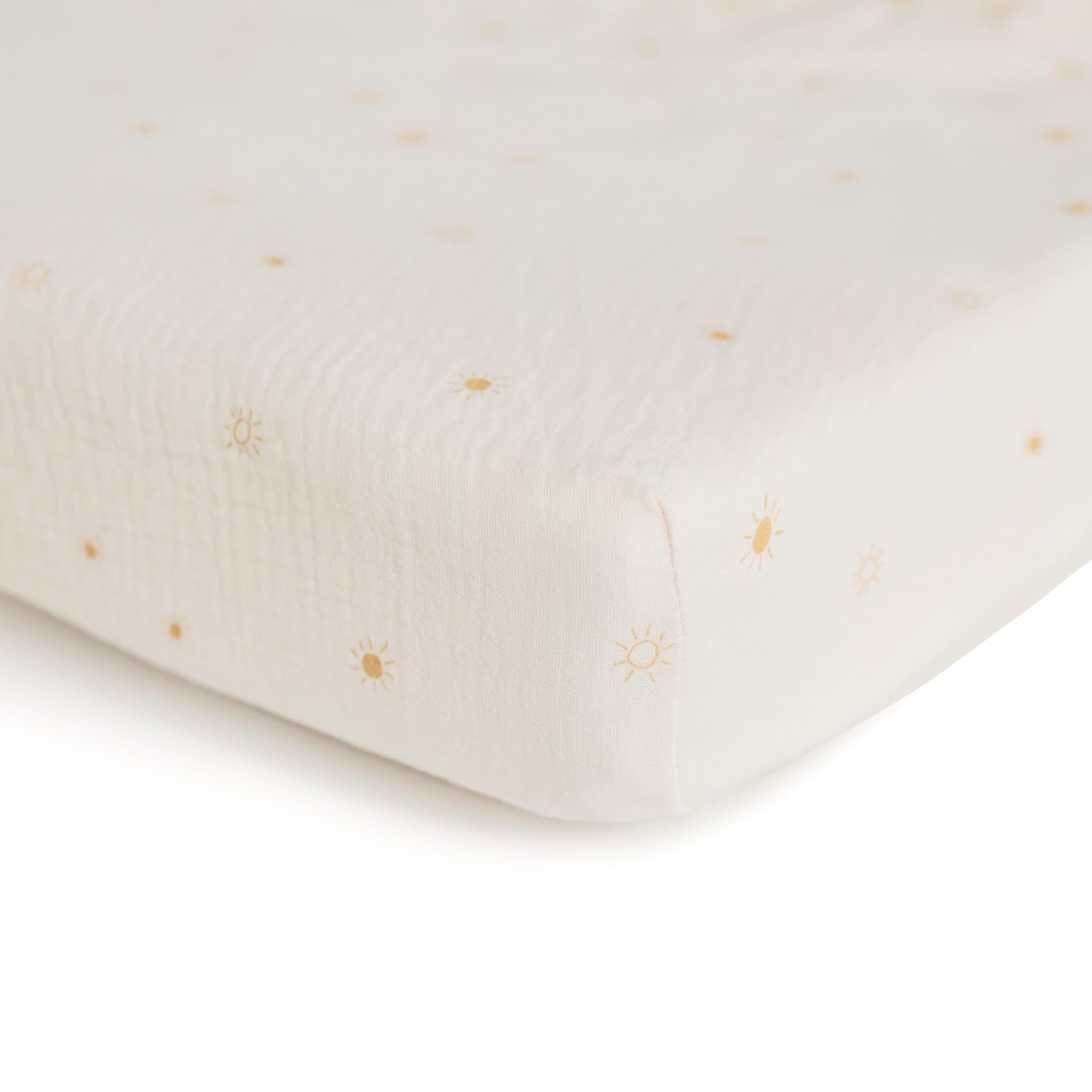 Mushie muslin fitted crib sheet on a crib shows snug fit and easy removal.