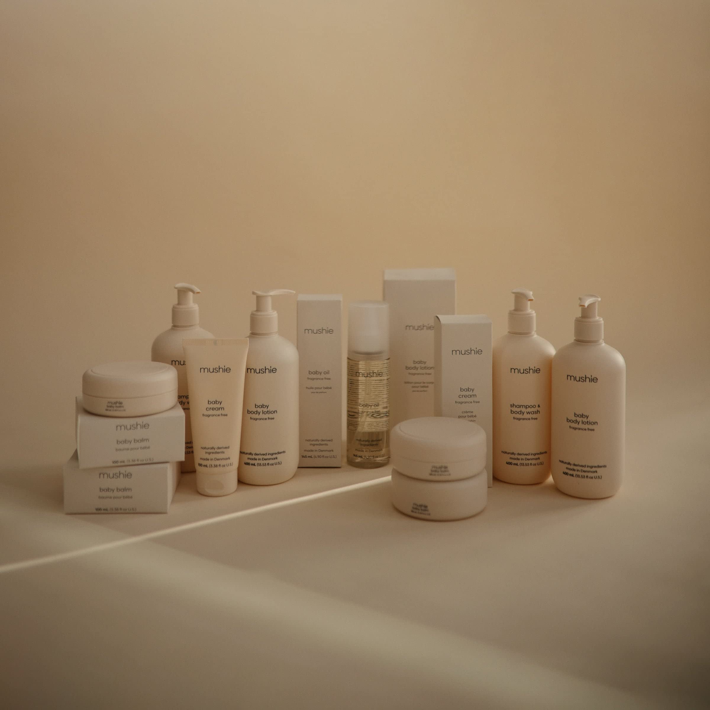 Mushie Organic Baby Oil massage-ready bottle emphasizes a calm bonding moment with baby.