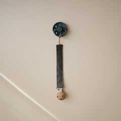 Mushie Pacifier Clip faux wood clasp closeup highlights secure grip