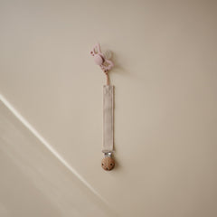Mushie two-pack pacifier clip on-the-go setup with olive and sand colors keeps pacifiers handy