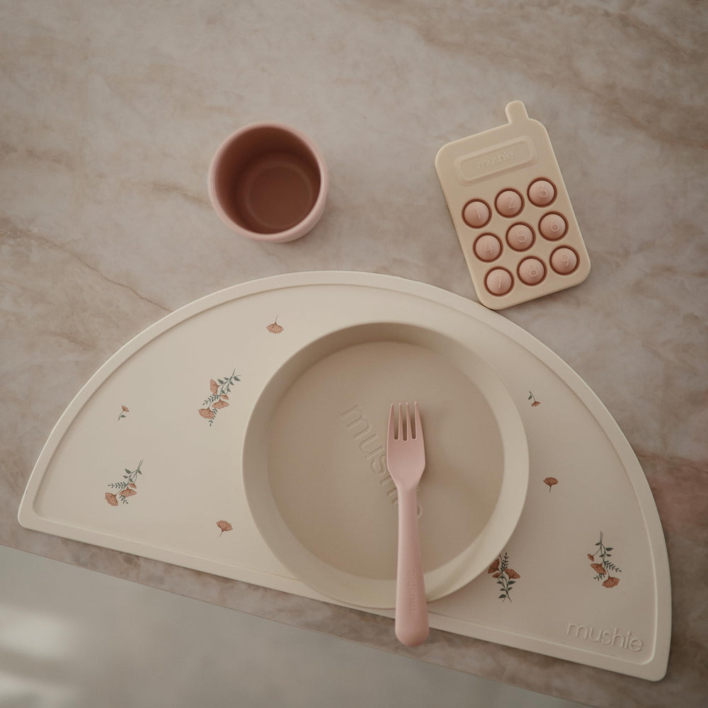 Mushie placemat in Sweden-inspired design, adds timeless elegance to kid's dining.