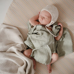 Mushie retro-stripes design adds gentle color to your nursery