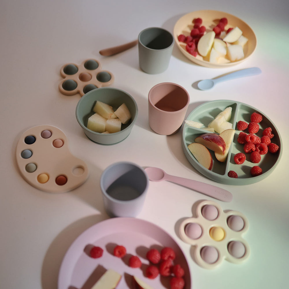 mushie self-feeding moments bowl in use helps little ones practice self-feeding.