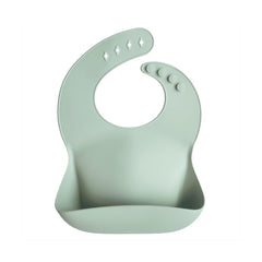 Mushie silicone baby bib adjustable fit Cambridge Blue, showing secure neck fasteners for growing babies.