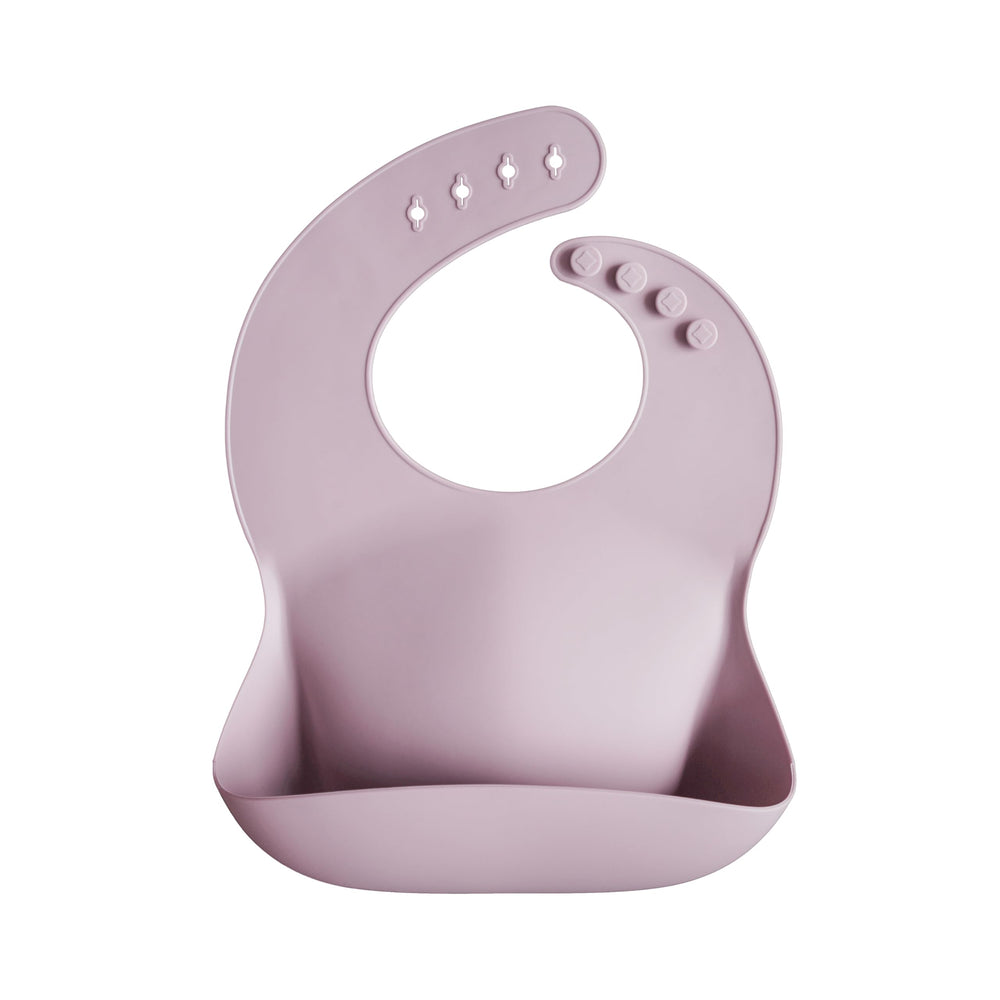 Mushie silicone baby bib shows adjustable neck for a snug fit during meals