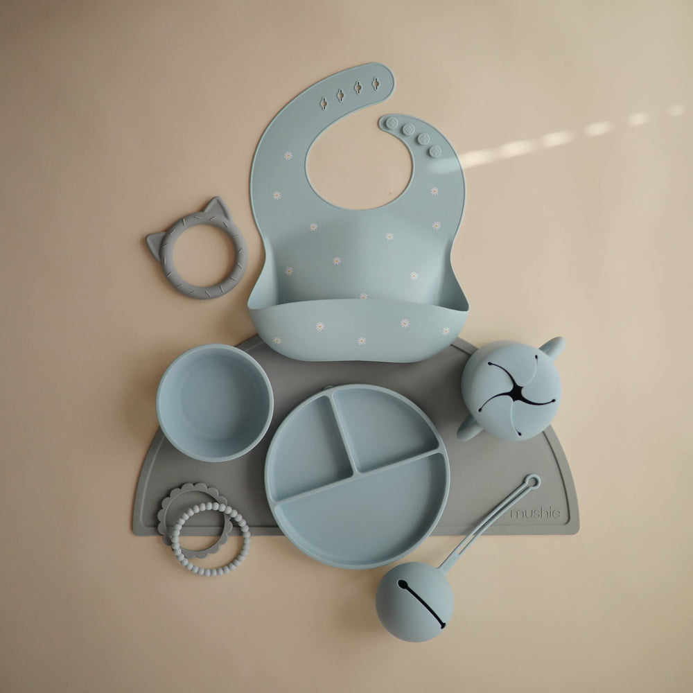 Mushie silicone baby bib adjustable neck strap demonstrates snug fit for growing babies