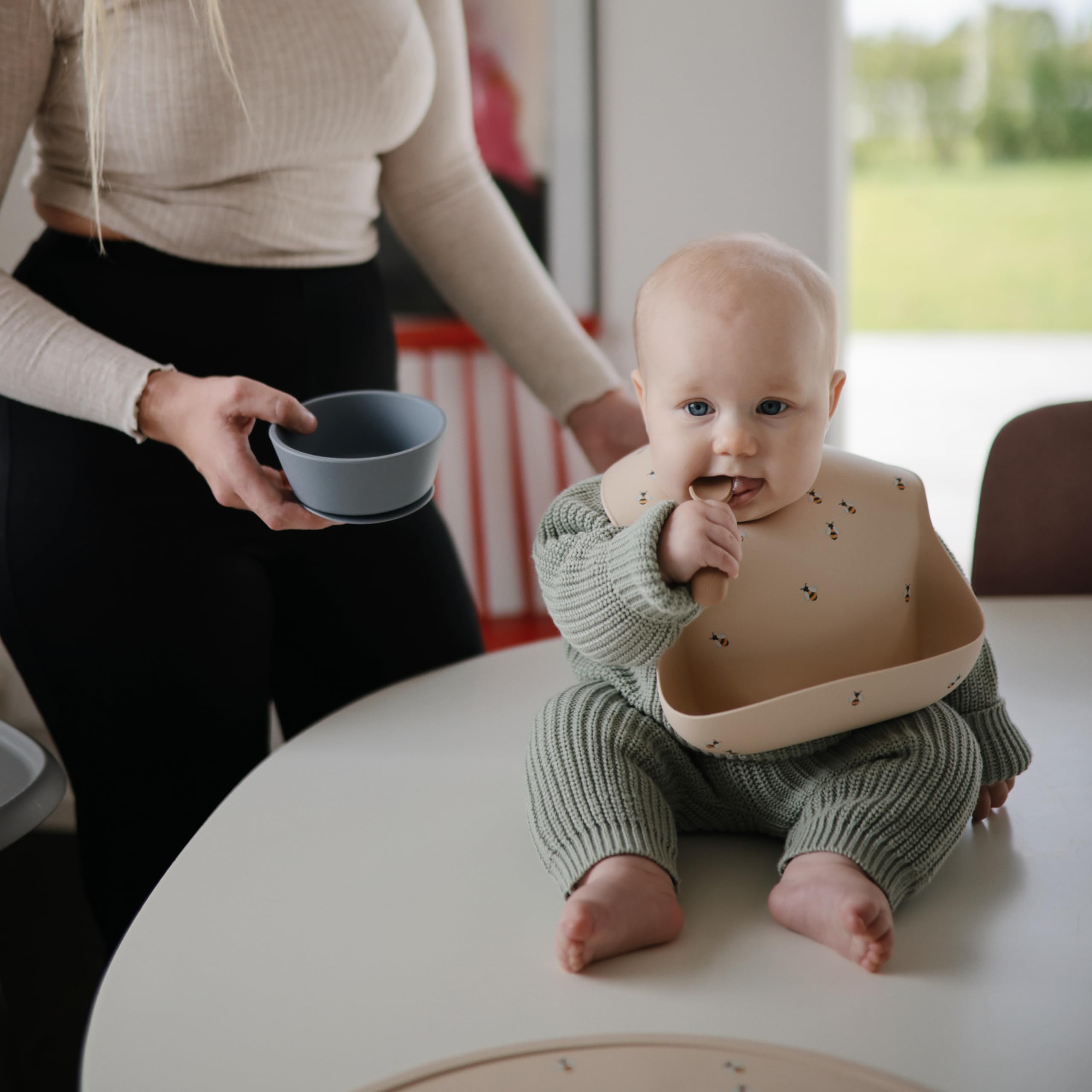 Mushie bib features built-in neck fasteners for a snug, comfortable mealtime fit