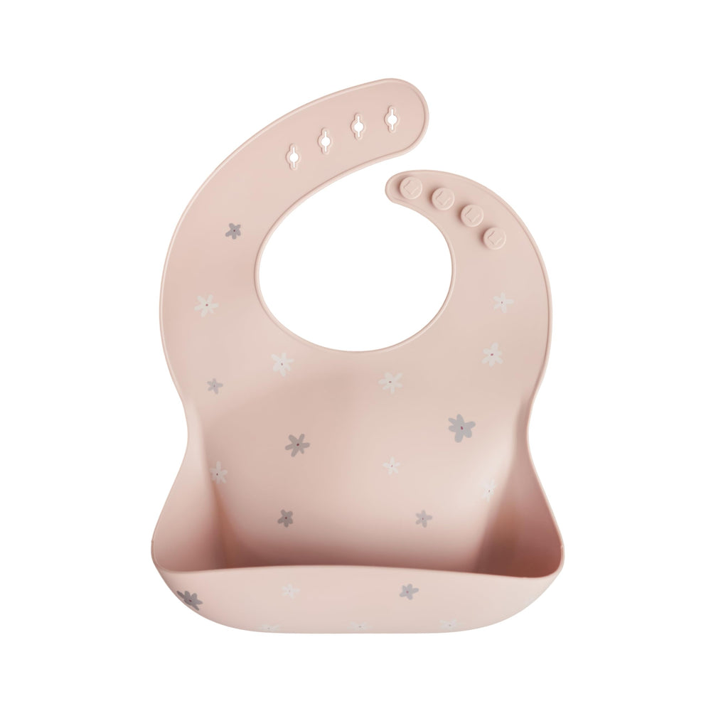 Mushie silicone baby bib Daisy with neck fastener for a snug fit.