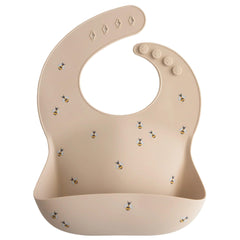 Mushie deep front pocket catches crumbs and drips to keep the table clean
