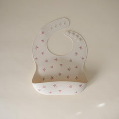 Mushie silicone baby bib with a deep pocket to catch crumbs and reduce mess