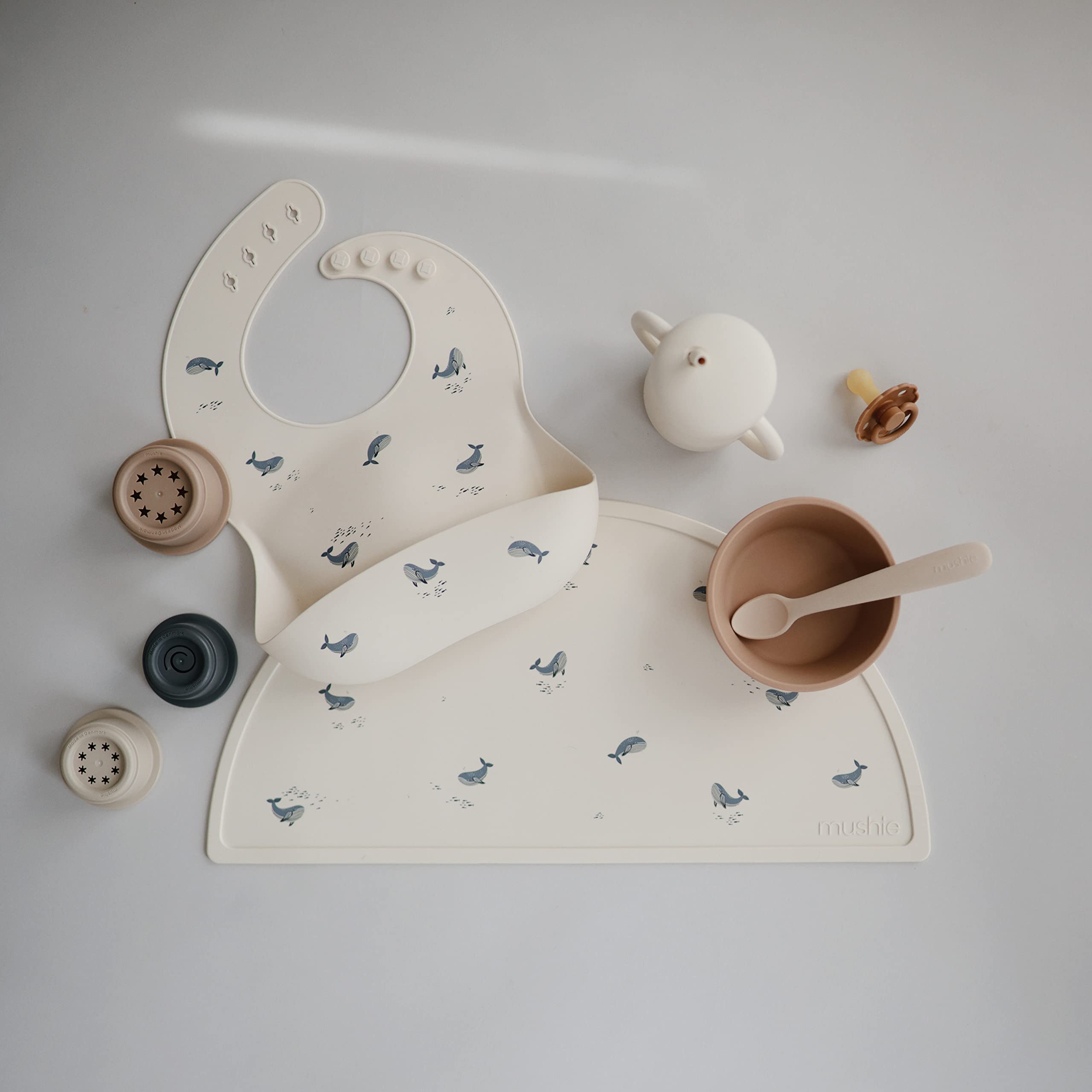 Mushie silicone baby bib deep-pocket keeps crumbs contained for less mess