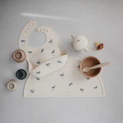 Mushie silicone baby bib deep-pocket keeps crumbs contained for less mess