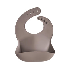Mushie silicone baby bib dove gray front view with adjustable neck for a snug fit for mess-free meals.