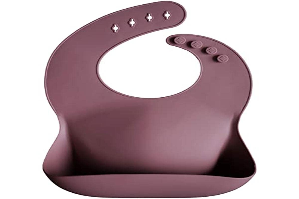 Mushie dusty rose bib with deep pocket ready to catch crumbs