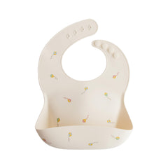 Mushie silicone baby bib adjustable fit close-up showing snug comfort during meals.