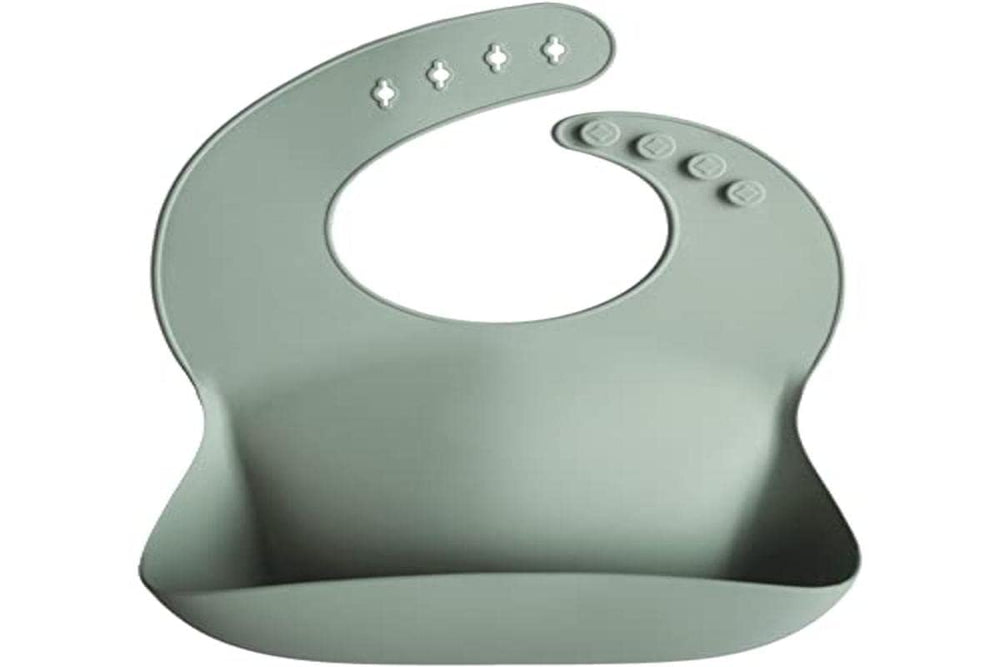 Mushie bib silicone material close-up emphasizing BPA-free, stain-resistant surface.