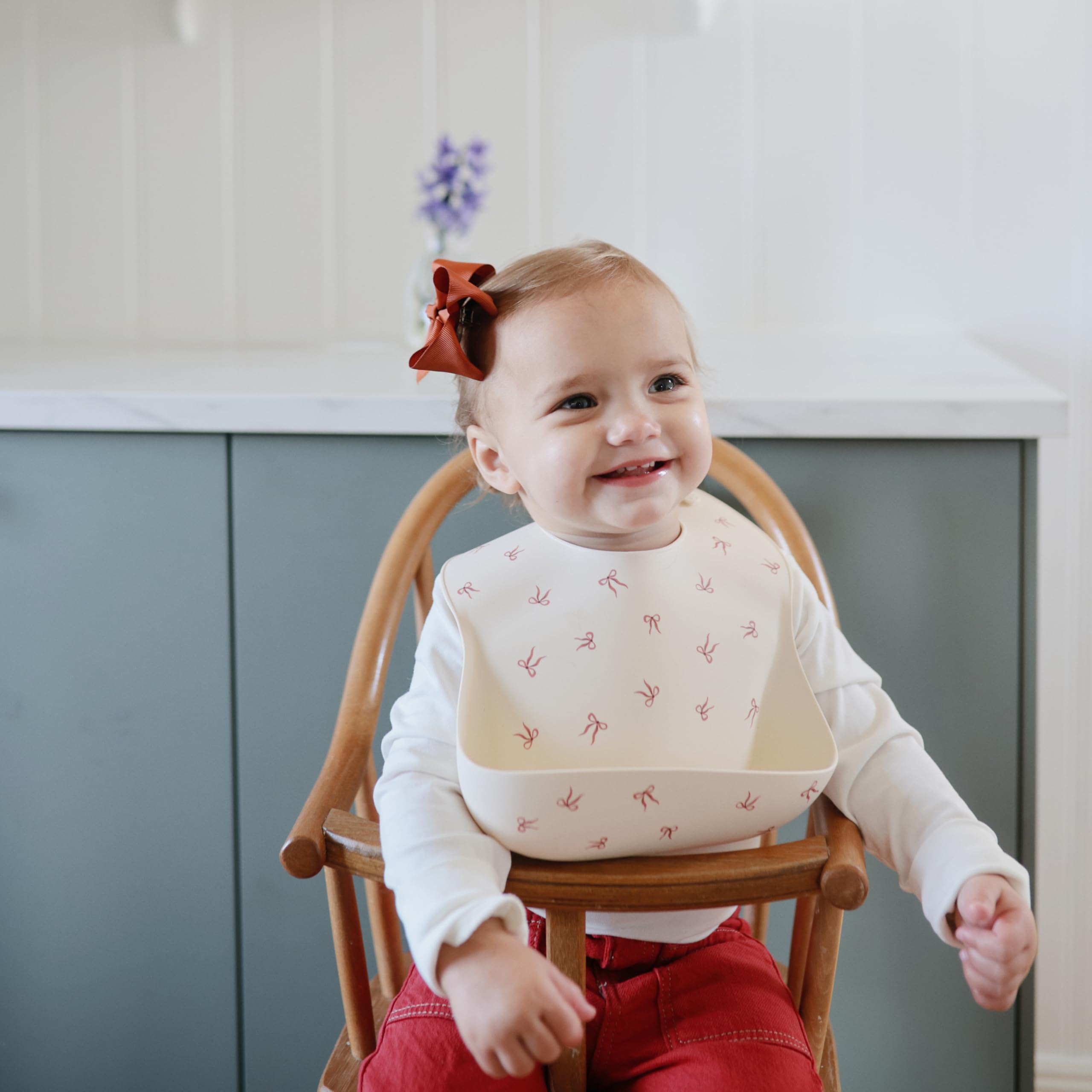 Mushie bows design silicone bib adds cute visual flair to mealtimes